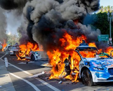 Photos show Waymo vehicles on fire during LA protests as company cuts downtown service