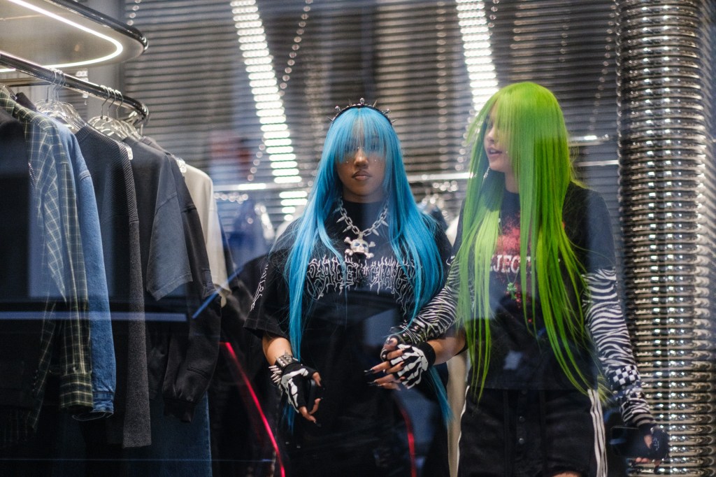 North West and a friend hold hands.