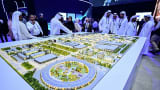Guests look at a model of the largest data center in the UAE under construction in Abu Dhabi as the Stargate initiative, a joint venture between G42, Microsoft, and OpenAI, during the Abu Dhabi International Petroleum Exhibition & Conference (ADIPEC) in Abu Dhabi on November 3, 2025. (Photo by Giuseppe CACACE / AFP) (Photo by GIUSEPPE CACACE/AFP via Getty Images)          