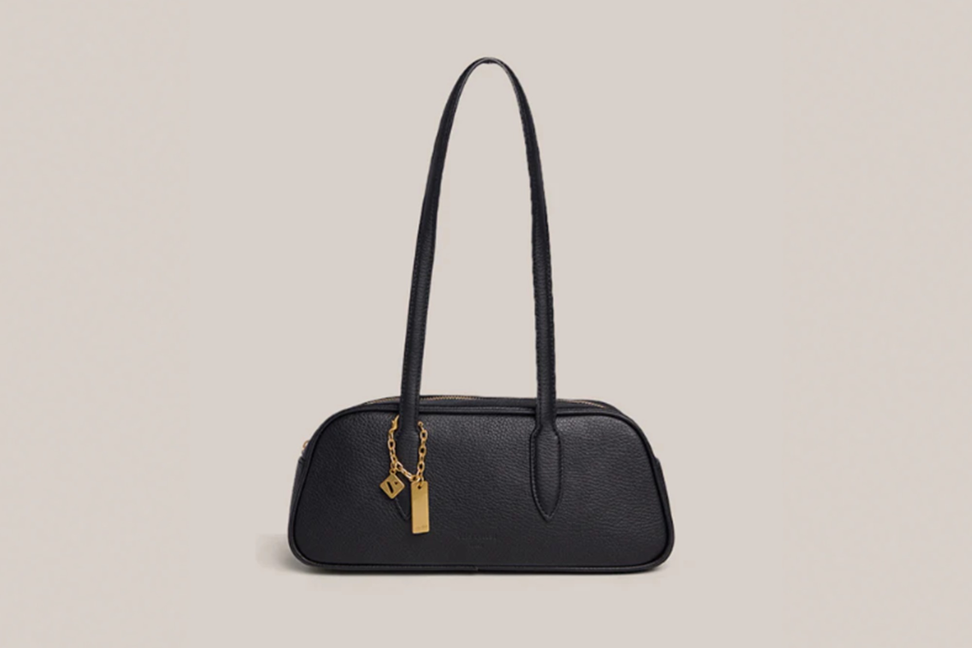 Black leather shoulder bag with a gold chain and two charms.