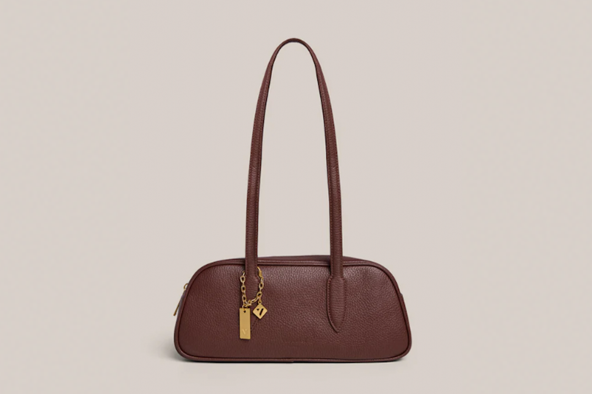 Brown leather handbag with gold charm.