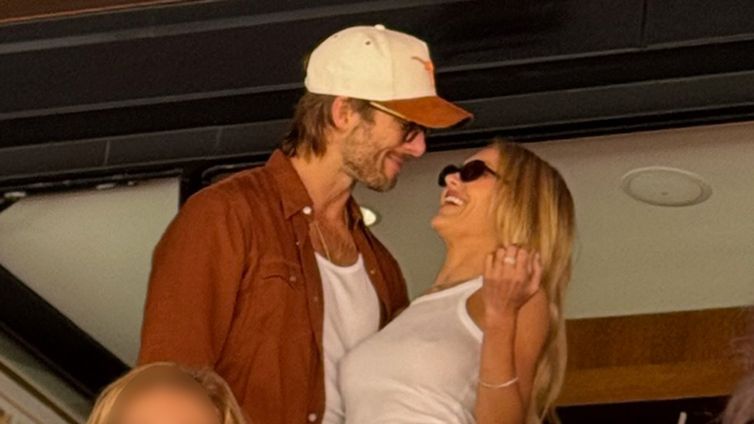 Glen Powell & Michelle Randolph All Smiles During Rare Outing At Texas-Tennessee Game